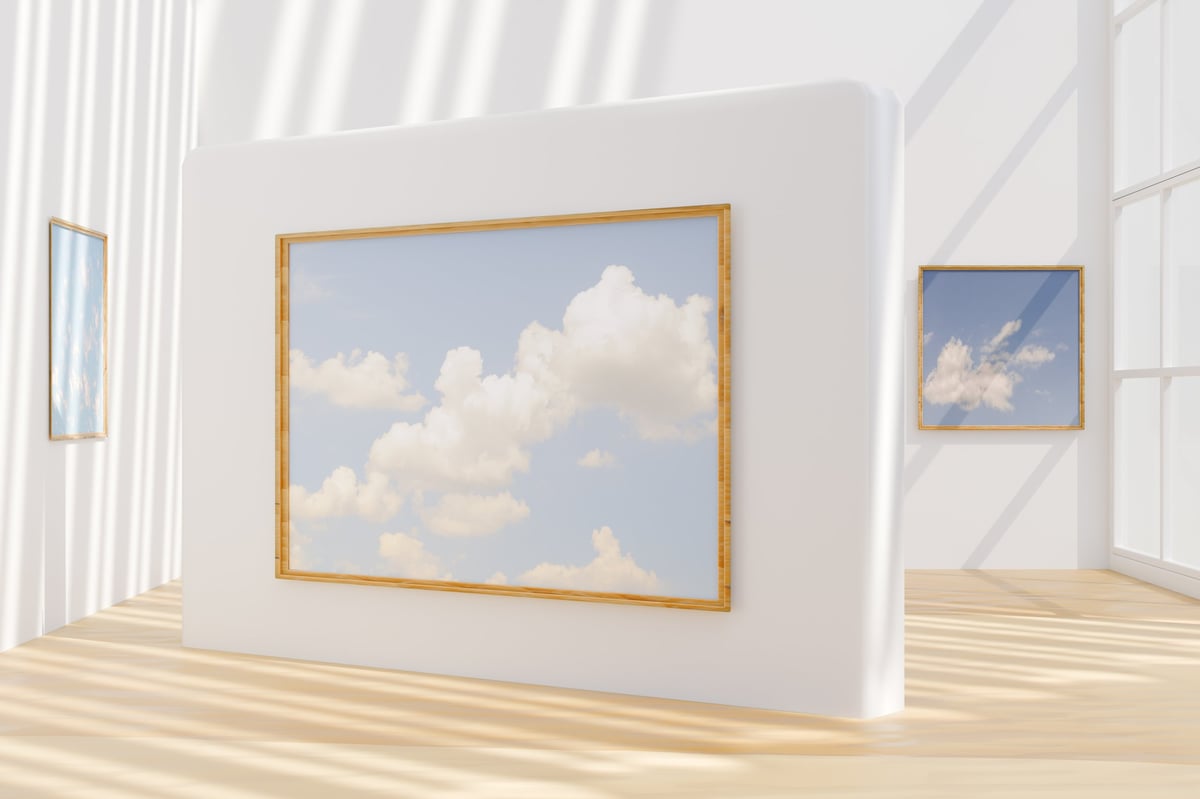 Gallery room showing a series of cloud-themed paintings on white walls